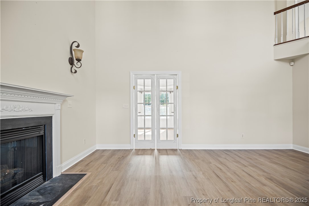 106 Linden Road Cameron, NC 28326 - Photo 7 of 48 an empty room with wooden floor cabinet and a fireplace