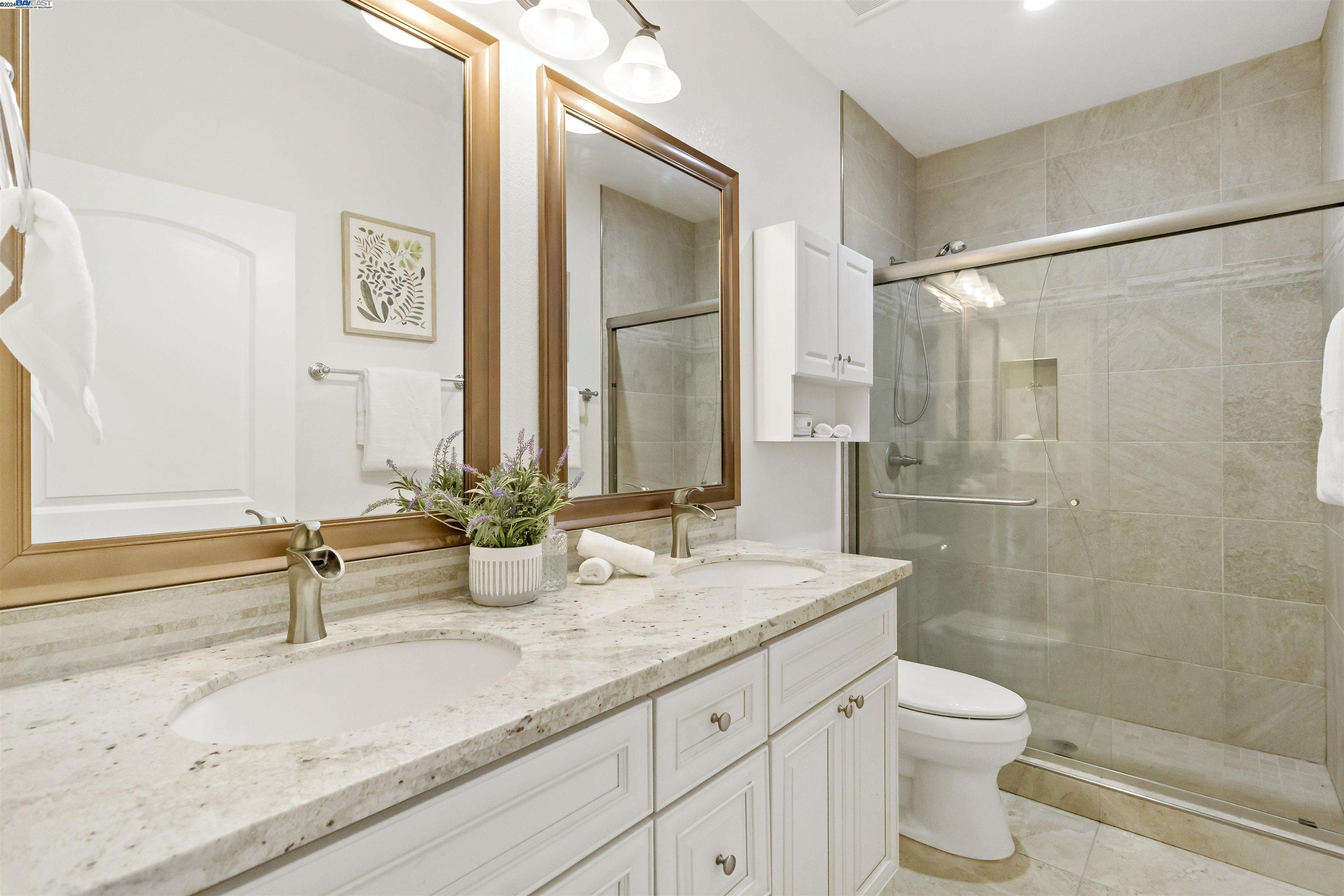 Warm Springs Fremont, CA 94539 - Photo 19 of 27 a bathroom with double sink and a mirror