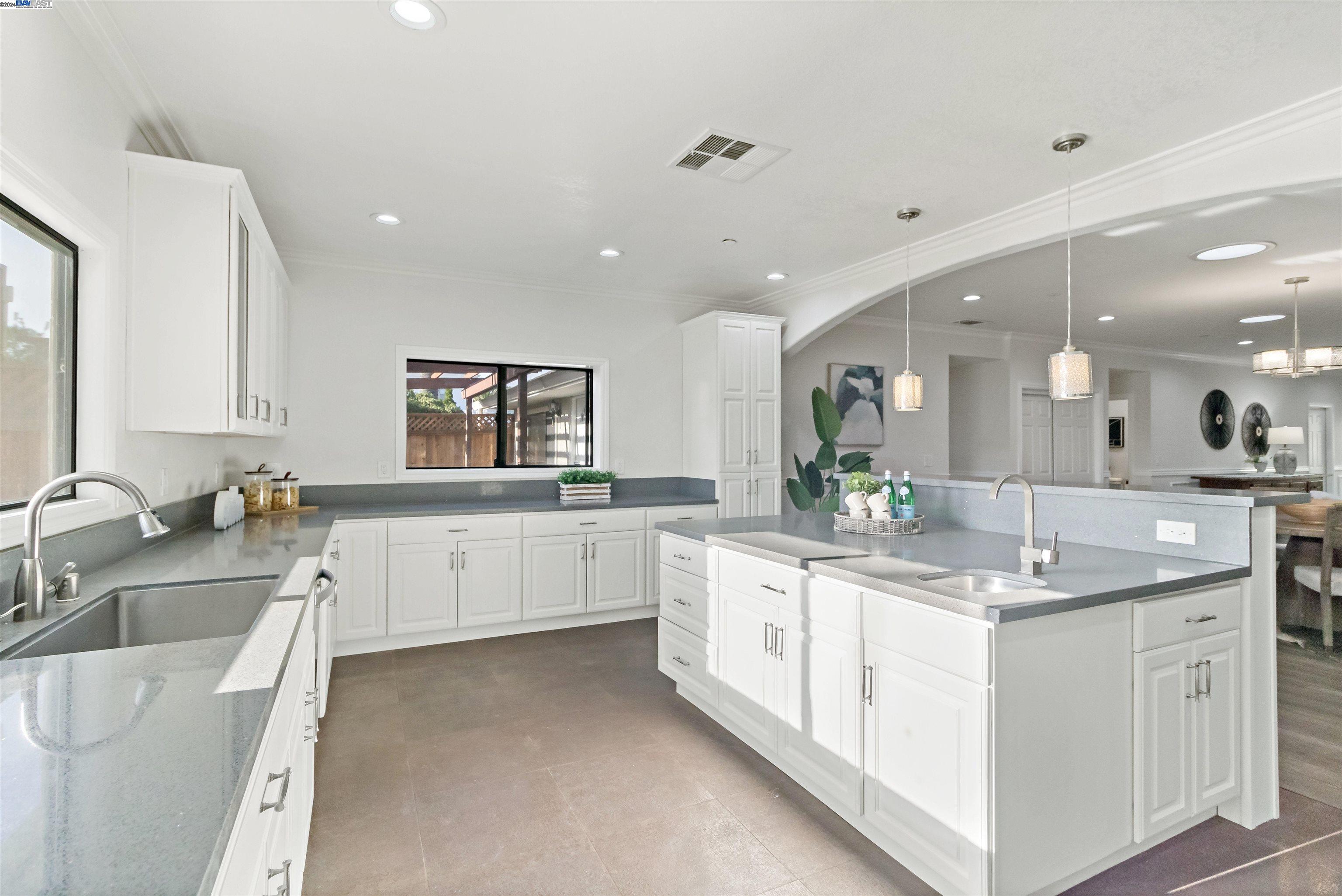 Warm Springs Fremont, CA 94539 - Photo 8 of 27 a large white kitchen with a lot of counter space and a sink