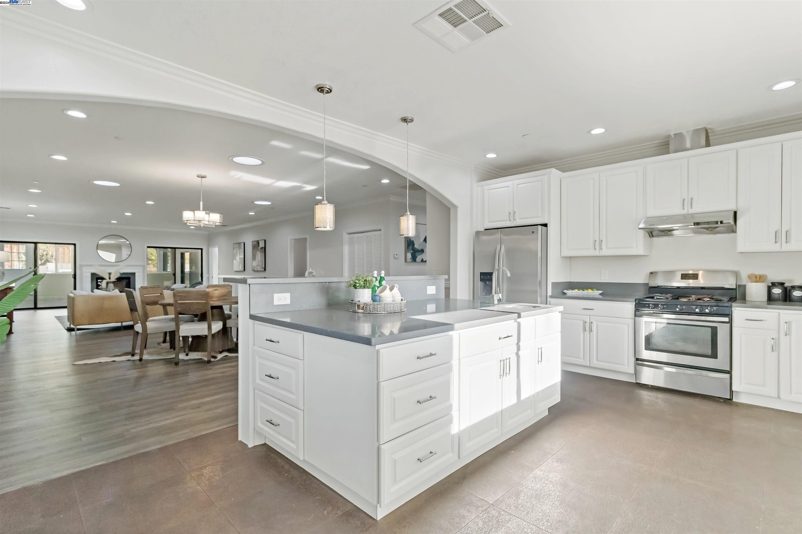 Warm Springs Fremont, CA 94539 - Photo 9 of 27 a large white kitchen with stainless steel appliances granite countertop lots of white cabinets a stove and a sink