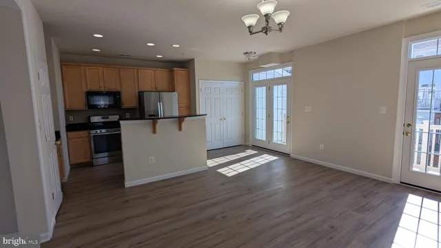 a kitchen with a refrigerator a stove a sink and a counter top space