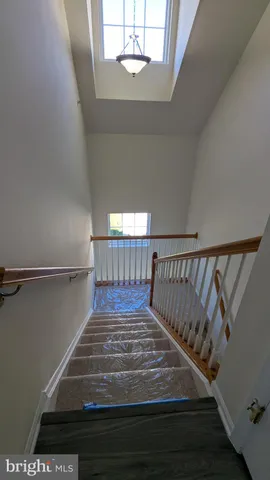 an empty room with wooden floor and entrance