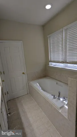 a bathroom with a tub and shower