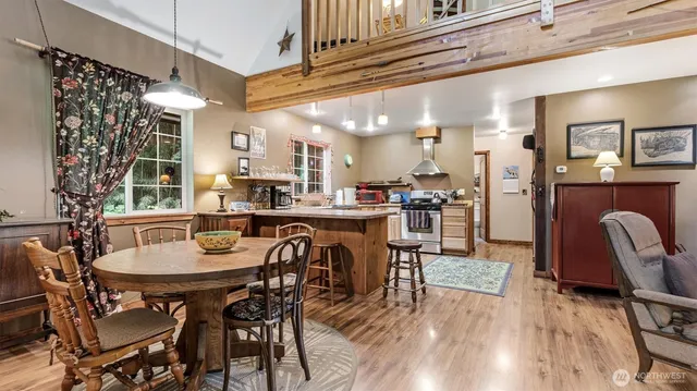 a dining room with furniture and wooden floor
