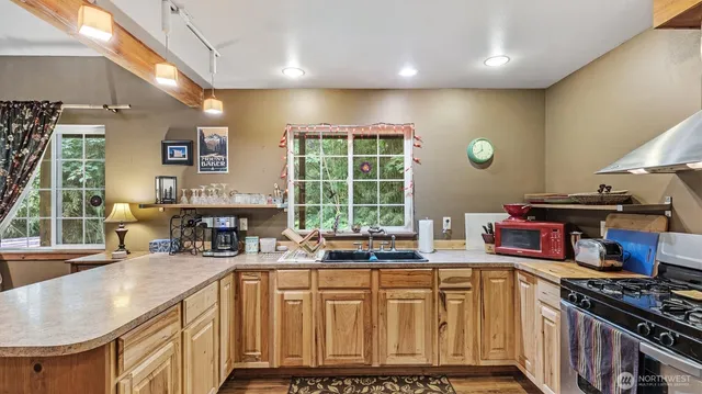 a kitchen with stainless steel appliances granite countertop a stove and a sink