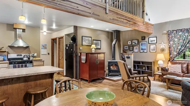 a work room with furniture a rug and a chandelier