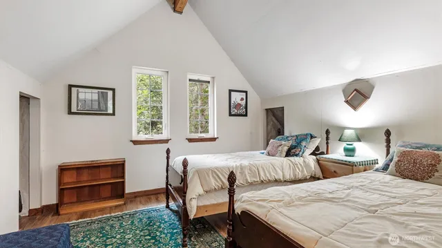 a bedroom with two beds and a window