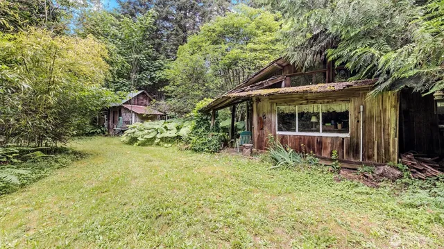 a view of a chair and table in backyard