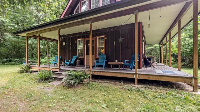 a view of house with yard and outdoor seating