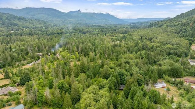 a view of a house with backyard porch and sitting area