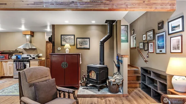 a living room with furniture a flat screen tv and gym equipment