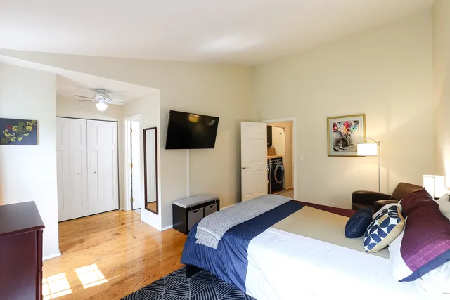 a bedroom with a bed and a flat screen tv