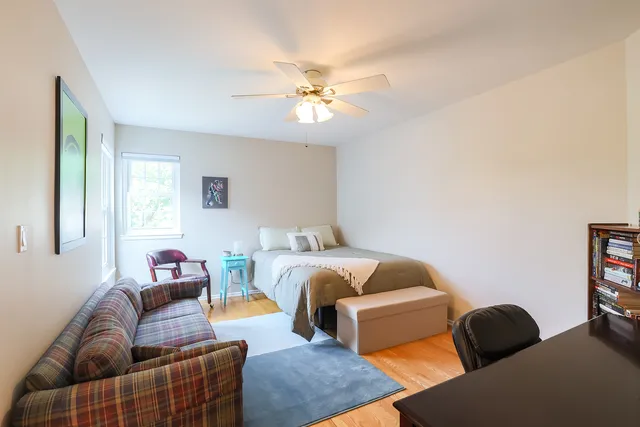 a bedroom with furniture and a chandelier