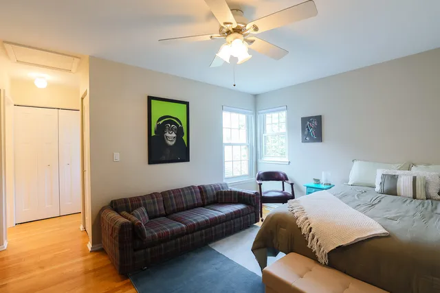 a bedroom with a bed lamps and a chandelier