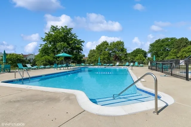 a view of a swimming pool with a yard