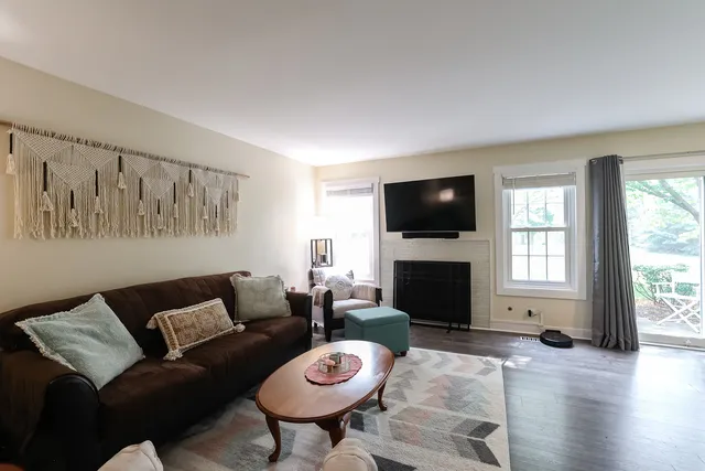 a living room with furniture a fireplace and a flat screen tv