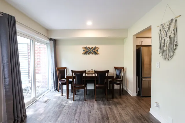 a view of a dining room with furniture and wooden floor