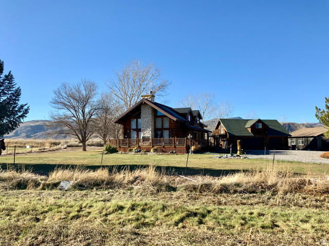 76 Highway 118 Monroe, UT 84754 - Photo 22 of 76 View of property exterior with a wooden deck, a yard, a chimney, and a view of rural / pastoral area