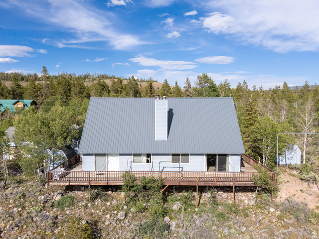 4770 Pine Crest Road Evanston, UT 82930 - Photo 16 of 24 A-frame residence with a light blue exterior and a gray metal roof