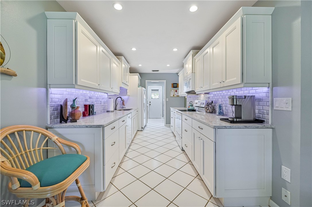 a kitchen with a sink cabinets and window