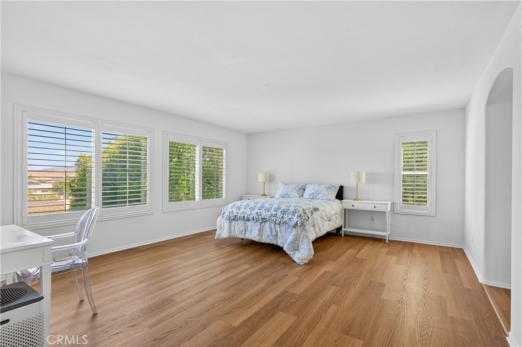 31928 Cercle Chambertin Temecula, CA 92591 - Photo 36 of 74 a bedroom with a bed and wooden floor