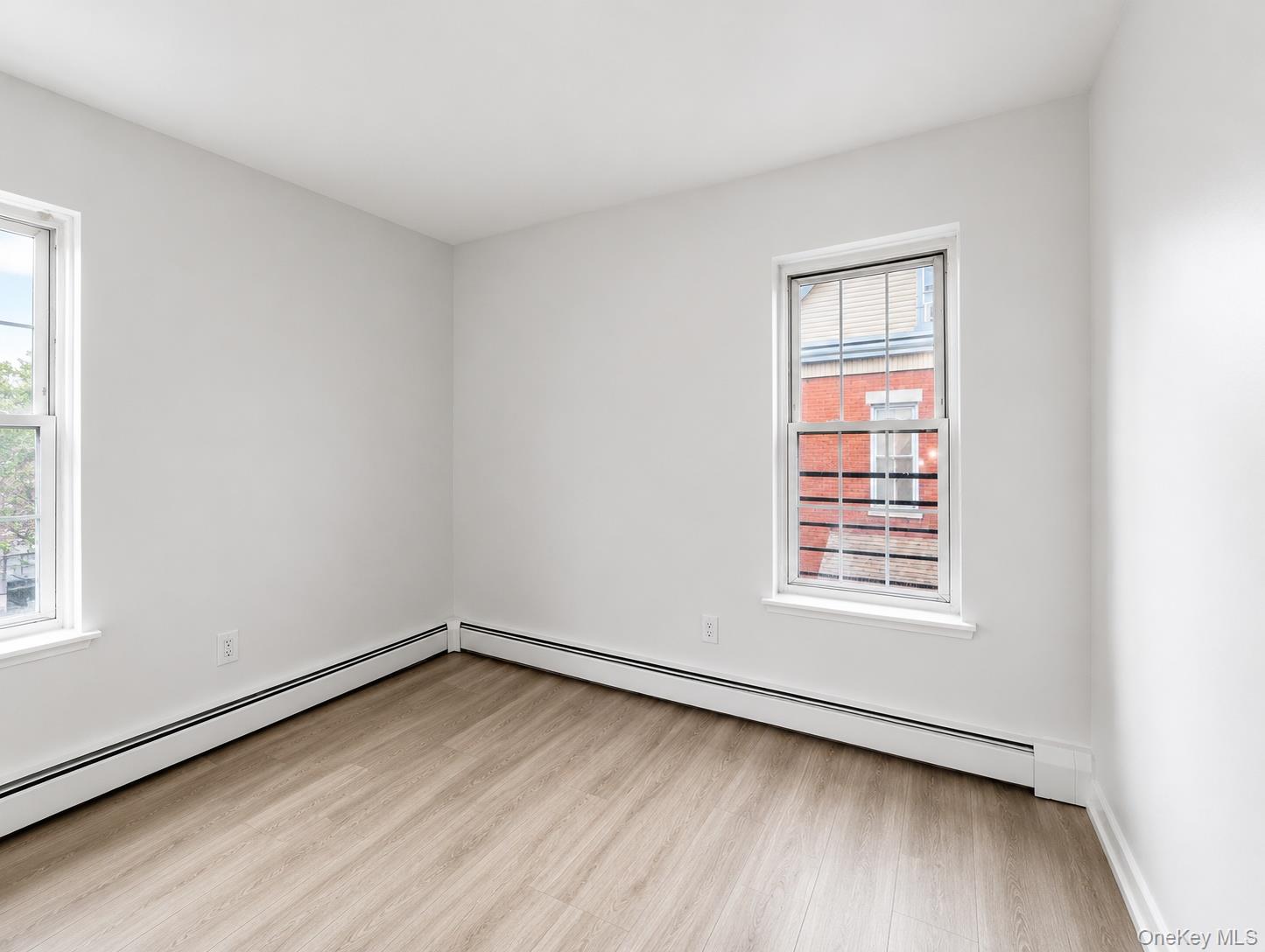 32 North Bridge Street Poughkeepsie, NY 12601 - Photo 15 of 19 an empty room with wooden floor and windows