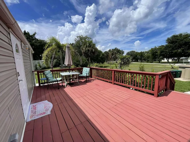 a view of a balcony with wooden floor and city view