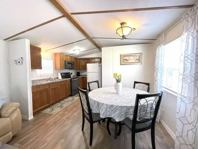 a view of a dining room with furniture and a chandelier
