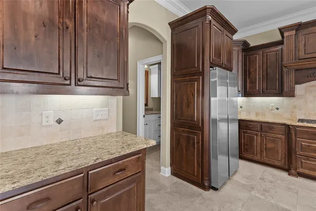 a kitchen with granite countertop stainless steel appliances and wooden cabinets