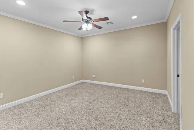 an empty room with a ceiling fan and a window