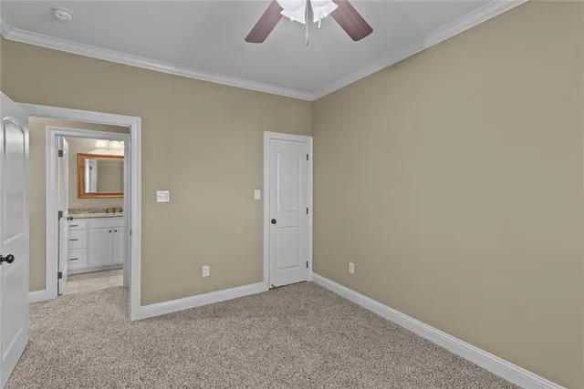 an empty room with closet and a chandelier fan