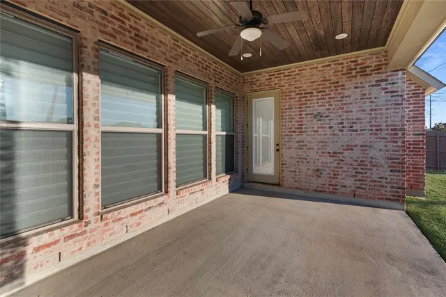 a view of a brick house with a large window