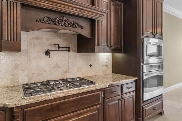 a stove top oven sitting inside of a kitchen