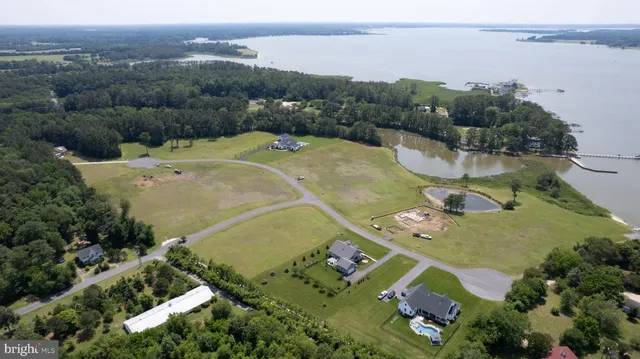 an aerial view of a house with a yard and lake view