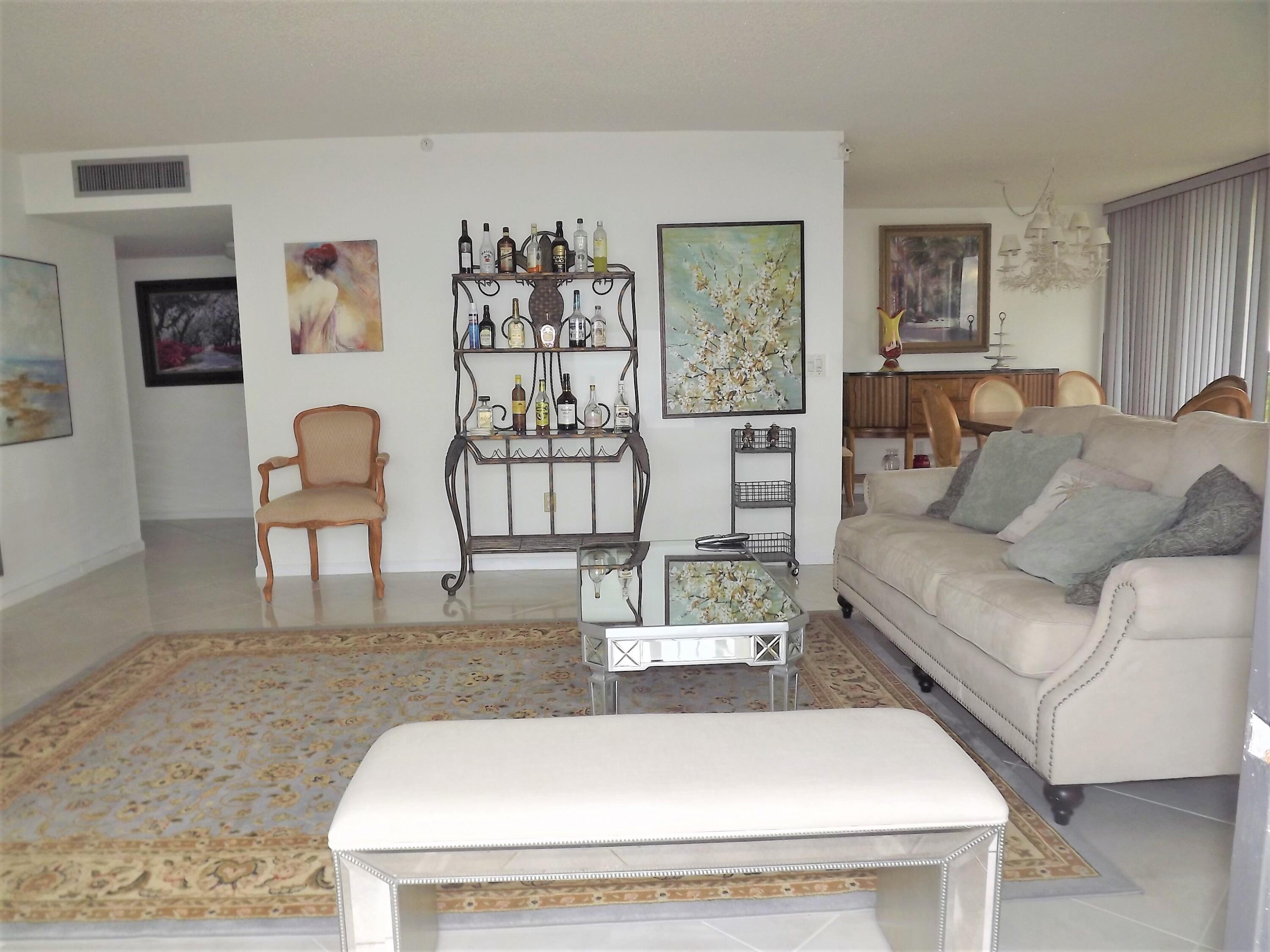 859 Jeffery Street, Unit 702 Boca Raton, FL 33487 - Photo 15 of 40 a living room with furniture and painting on the wall