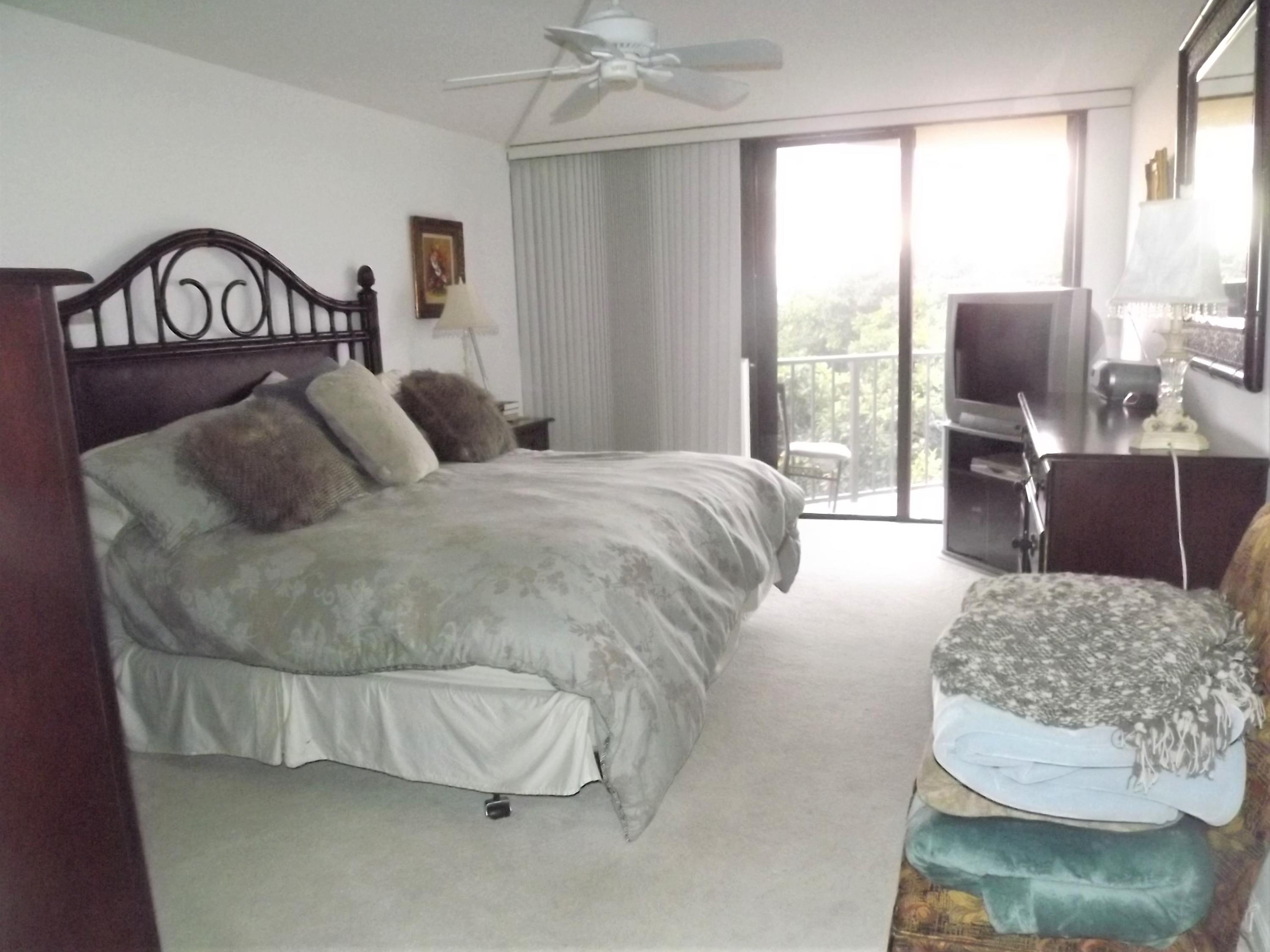 859 Jeffery Street, Unit 702 Boca Raton, FL 33487 - Photo 18 of 40 a living room with furniture and a flat screen tv
