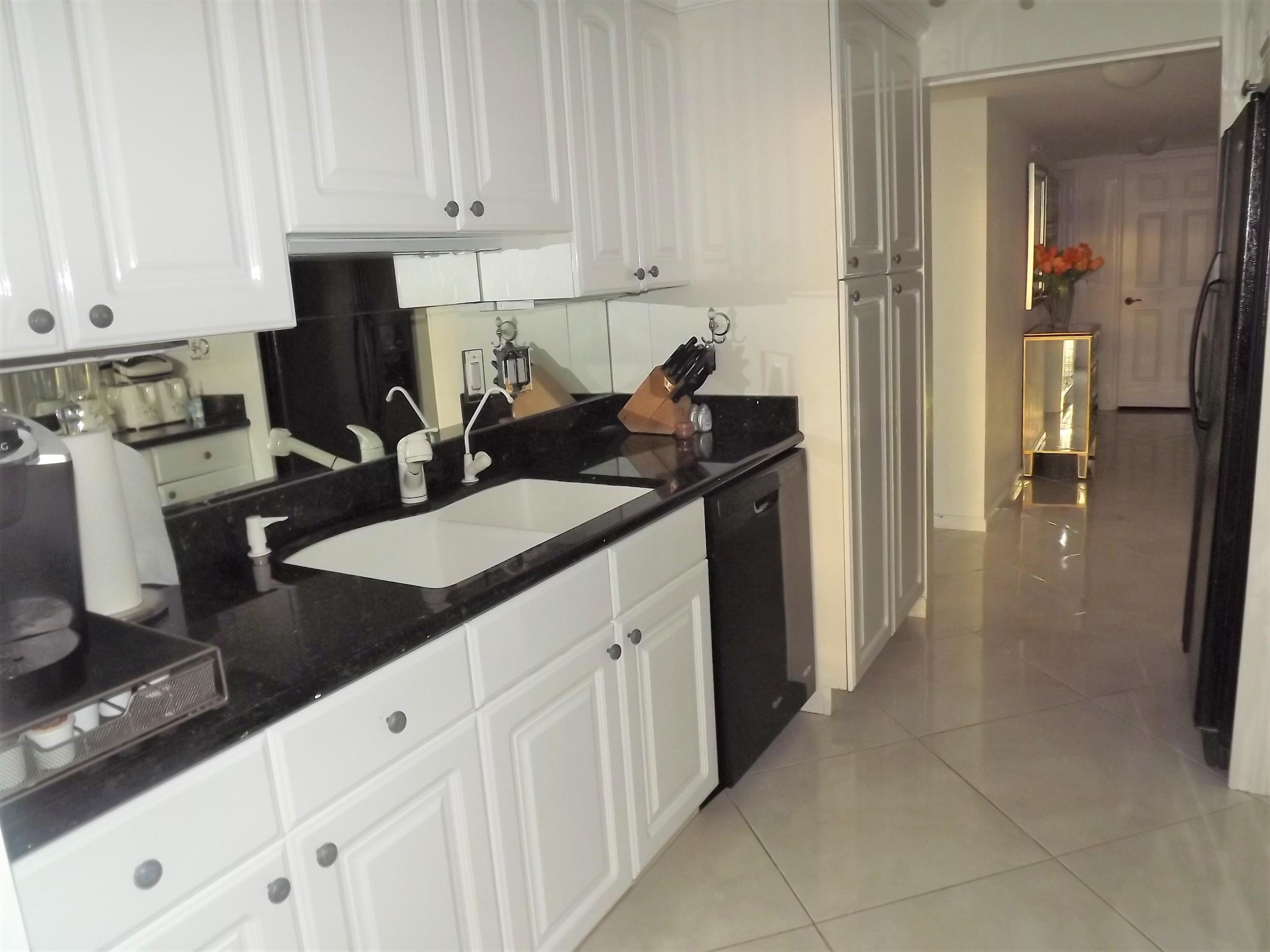 859 Jeffery Street, Unit 702 Boca Raton, FL 33487 - Photo 29 of 40 a kitchen with a sink and cabinets