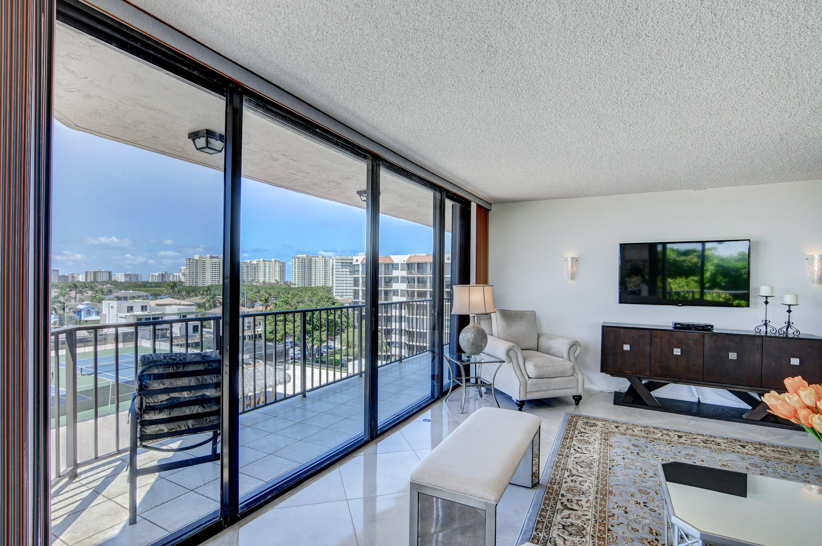 859 Jeffery Street, Unit 702 Boca Raton, FL 33487 - Photo 3 of 40 a living room with furniture and a flat screen tv
