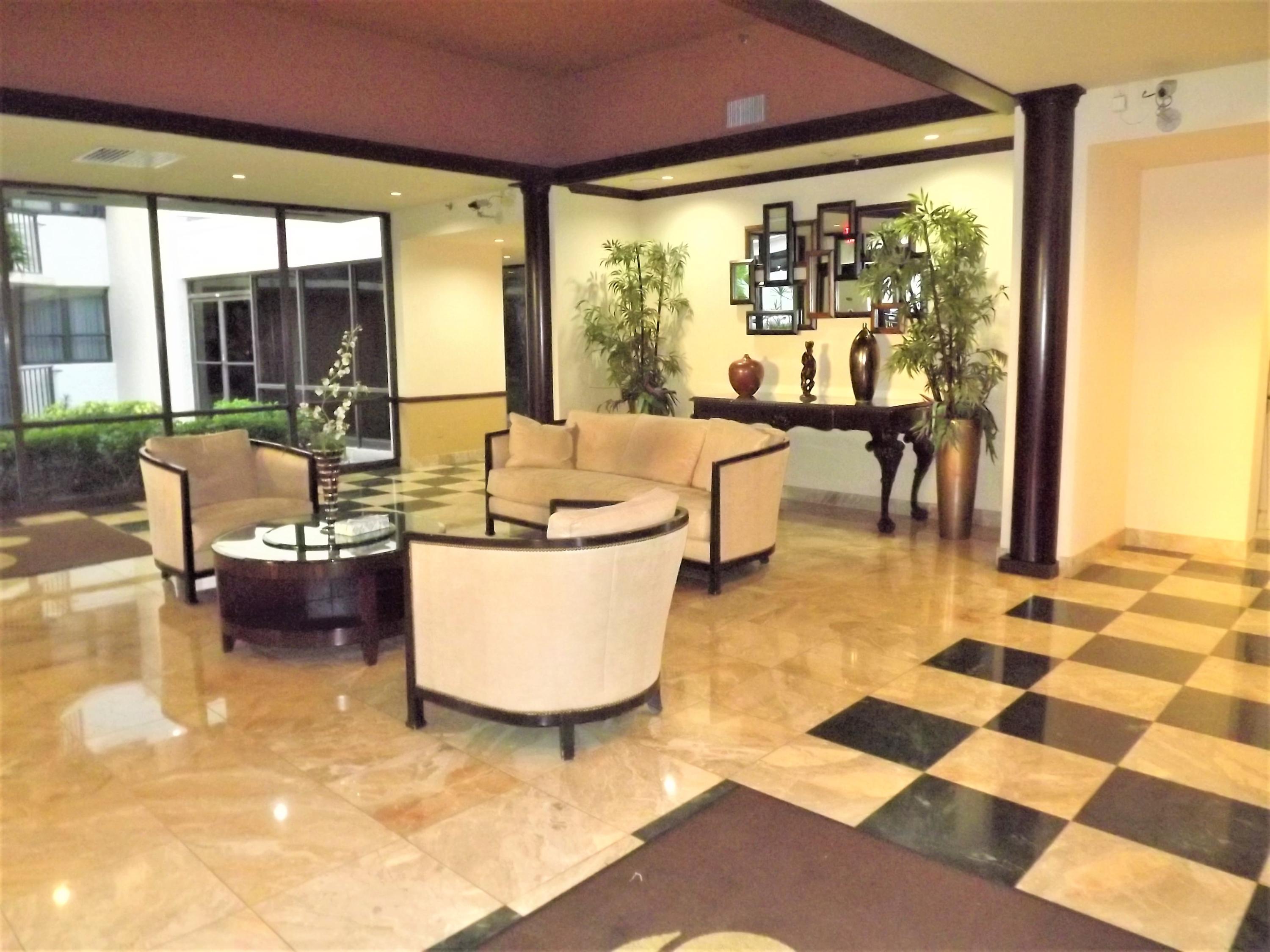 859 Jeffery Street, Unit 702 Boca Raton, FL 33487 - Photo 31 of 40 a living room with a patio and a couch
