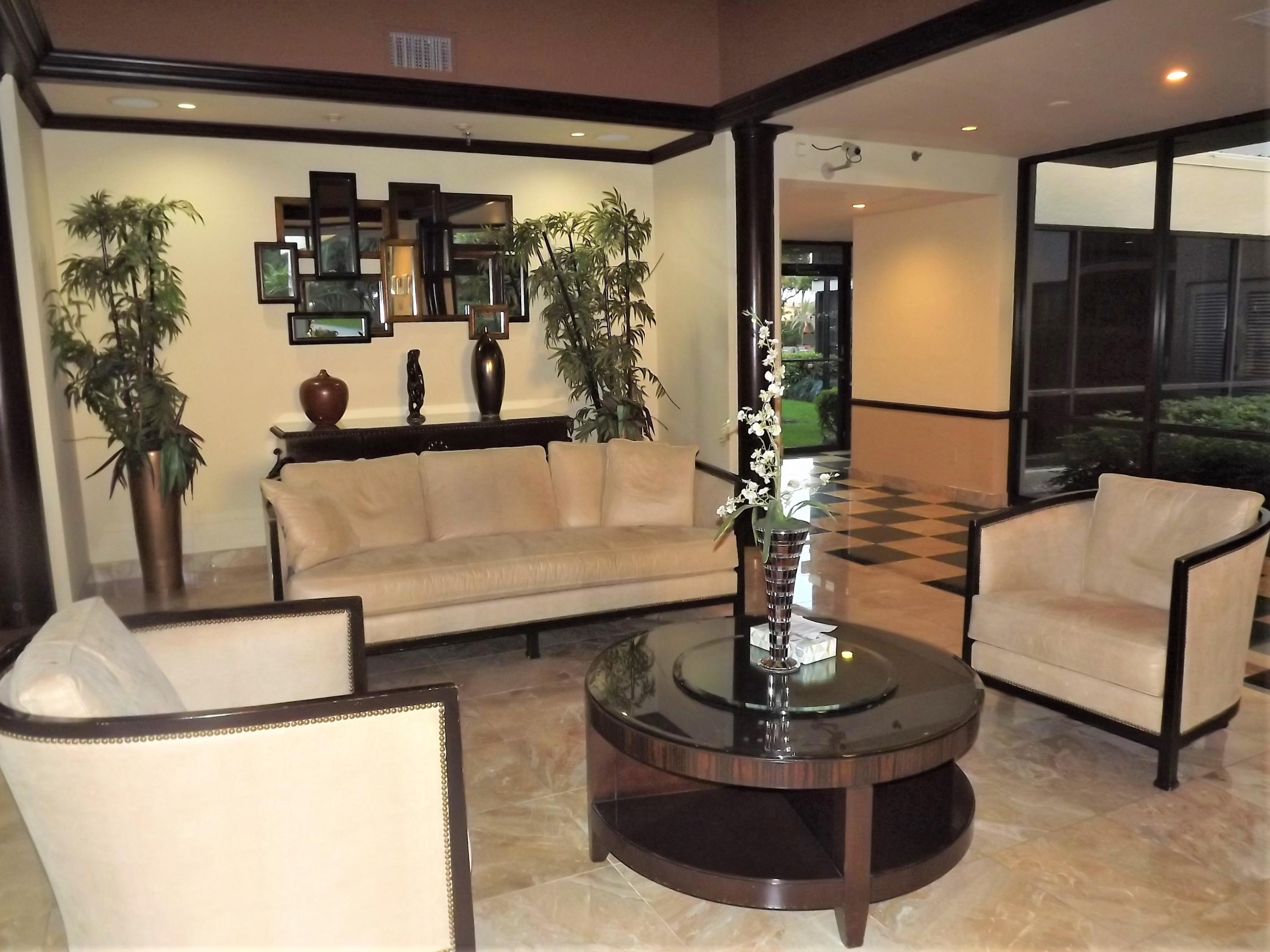 859 Jeffery Street, Unit 702 Boca Raton, FL 33487 - Photo 32 of 40 a living room with furniture and a potted plant
