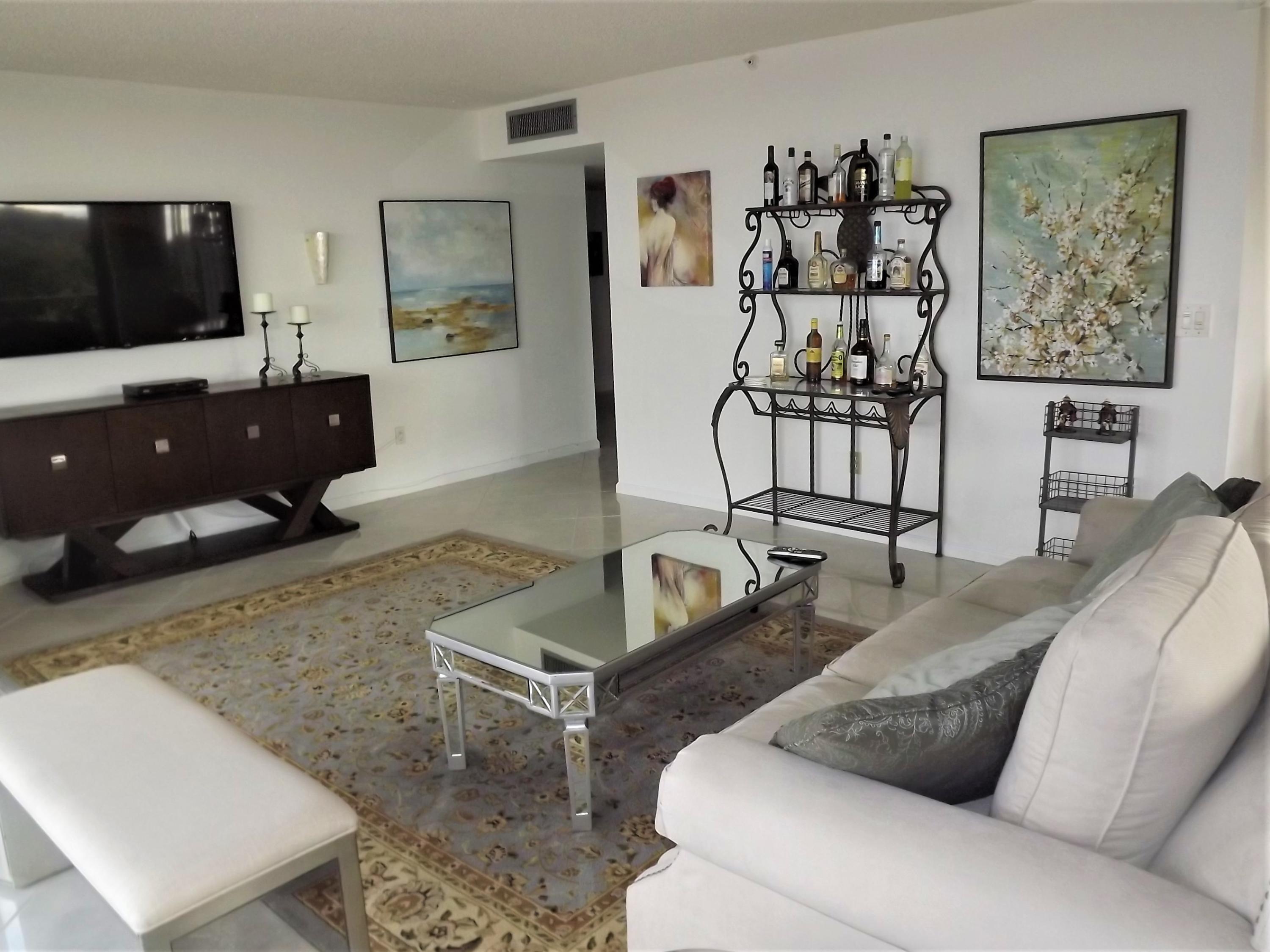 859 Jeffery Street, Unit 702 Boca Raton, FL 33487 - Photo 36 of 40 a living room with furniture and a flat screen tv