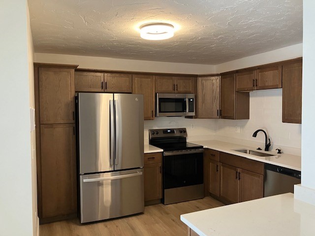 1000 Lexington Street, Unit 42 Waltham, MA 02451 - Photo 1 of 5 a kitchen with stainless steel appliances a refrigerator stove microwave and sink
