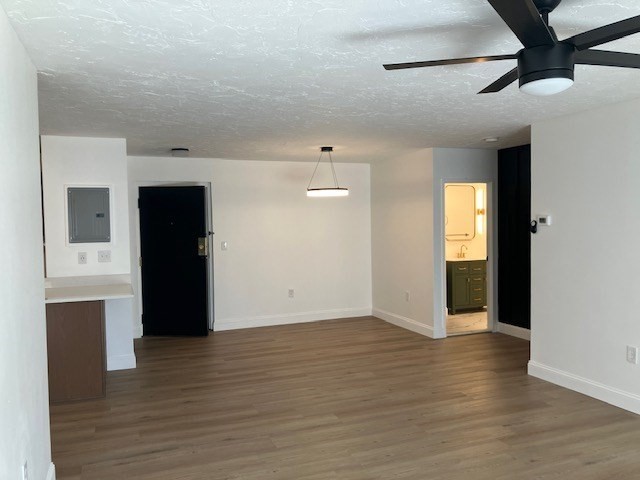 1000 Lexington Street, Unit 42 Waltham, MA 02451 - Photo 2 of 5 a view of an empty room with wooden floor and a window