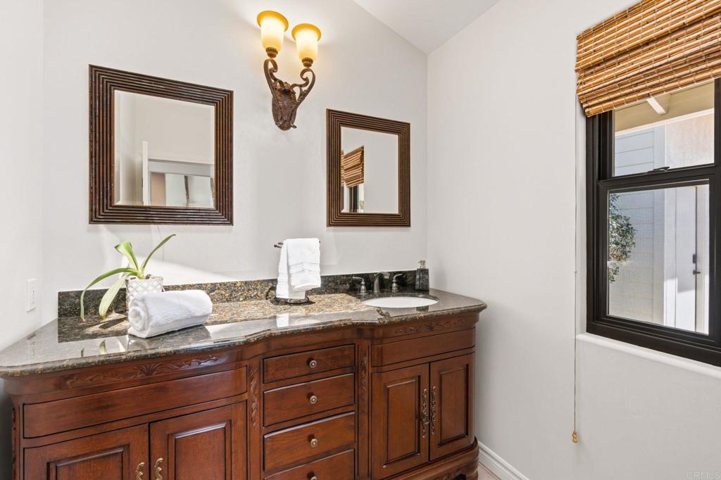13319 Pacer Lane Poway, CA 92064 - Photo 20 of 75 a bathroom with a granite countertop double vanity sink and a mirror