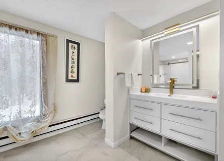 a bathroom with a double vanity sink mirror and shower