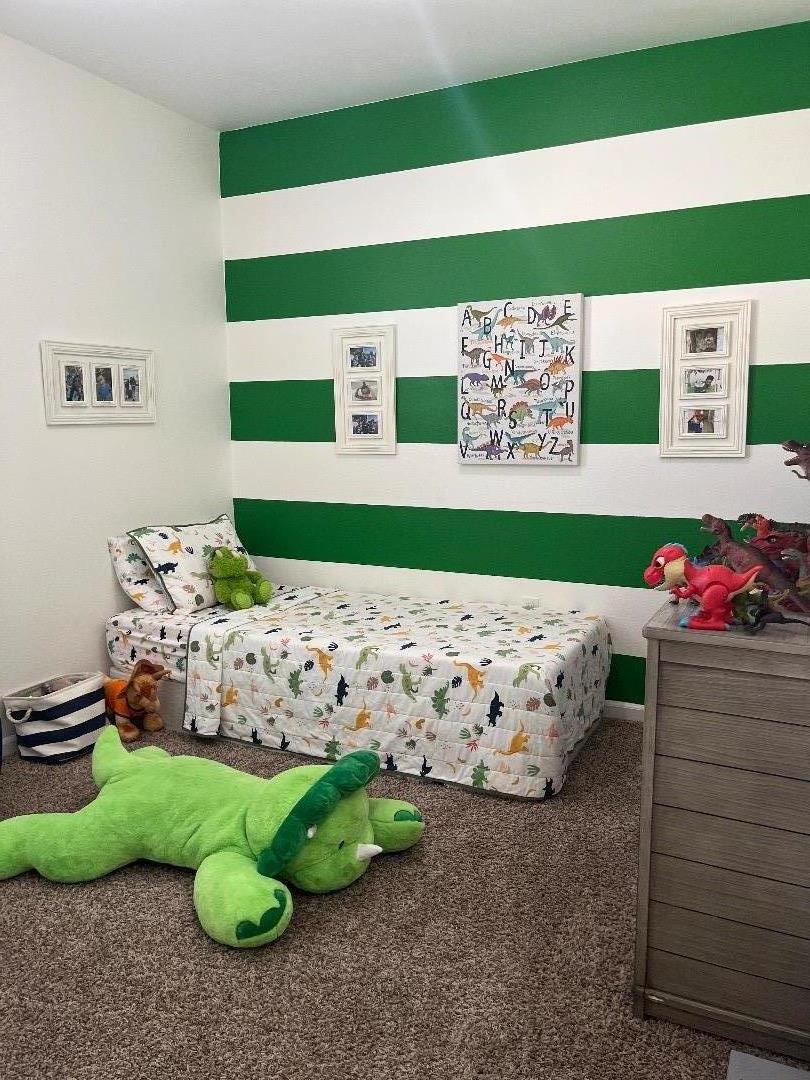 1705 Piazza Drive Salinas, CA 93905 - Photo 13 of 29 a bed sitting in a bedroom next to a window with cabinet