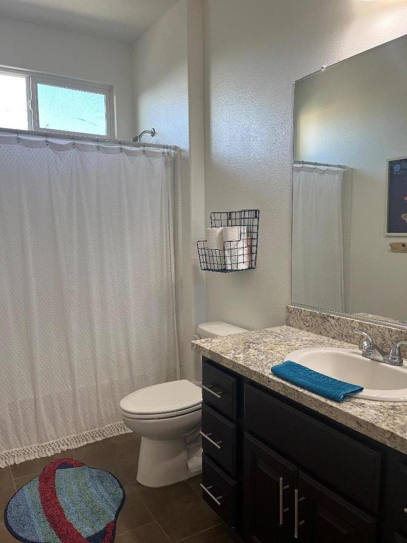 1705 Piazza Drive Salinas, CA 93905 - Photo 15 of 29 a bathroom with a granite countertop sink and a mirror