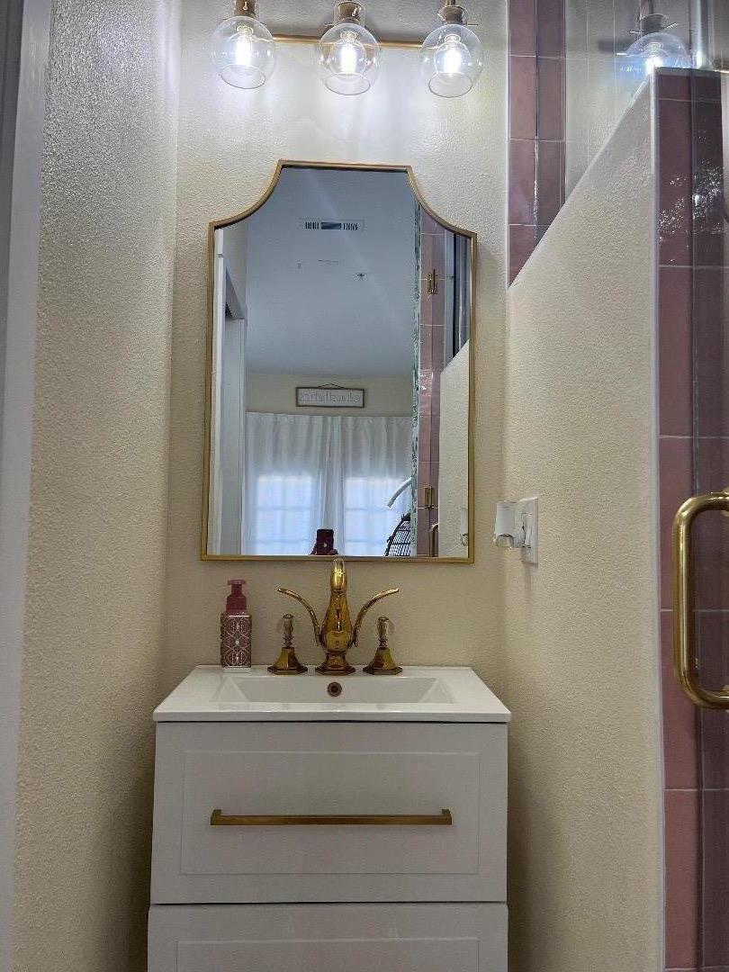1705 Piazza Drive Salinas, CA 93905 - Photo 23 of 29 a bathroom with a sink and a mirror