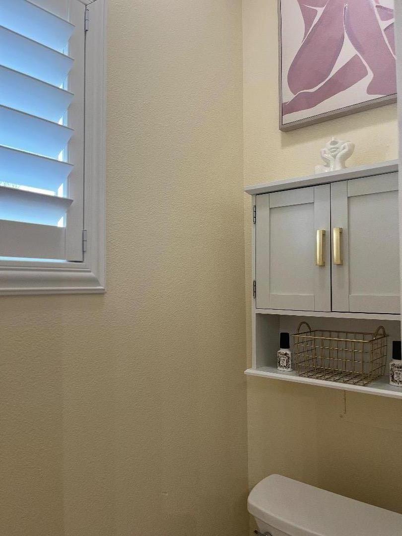 1705 Piazza Drive Salinas, CA 93905 - Photo 24 of 29 a bathroom with a toilet sink and mirror