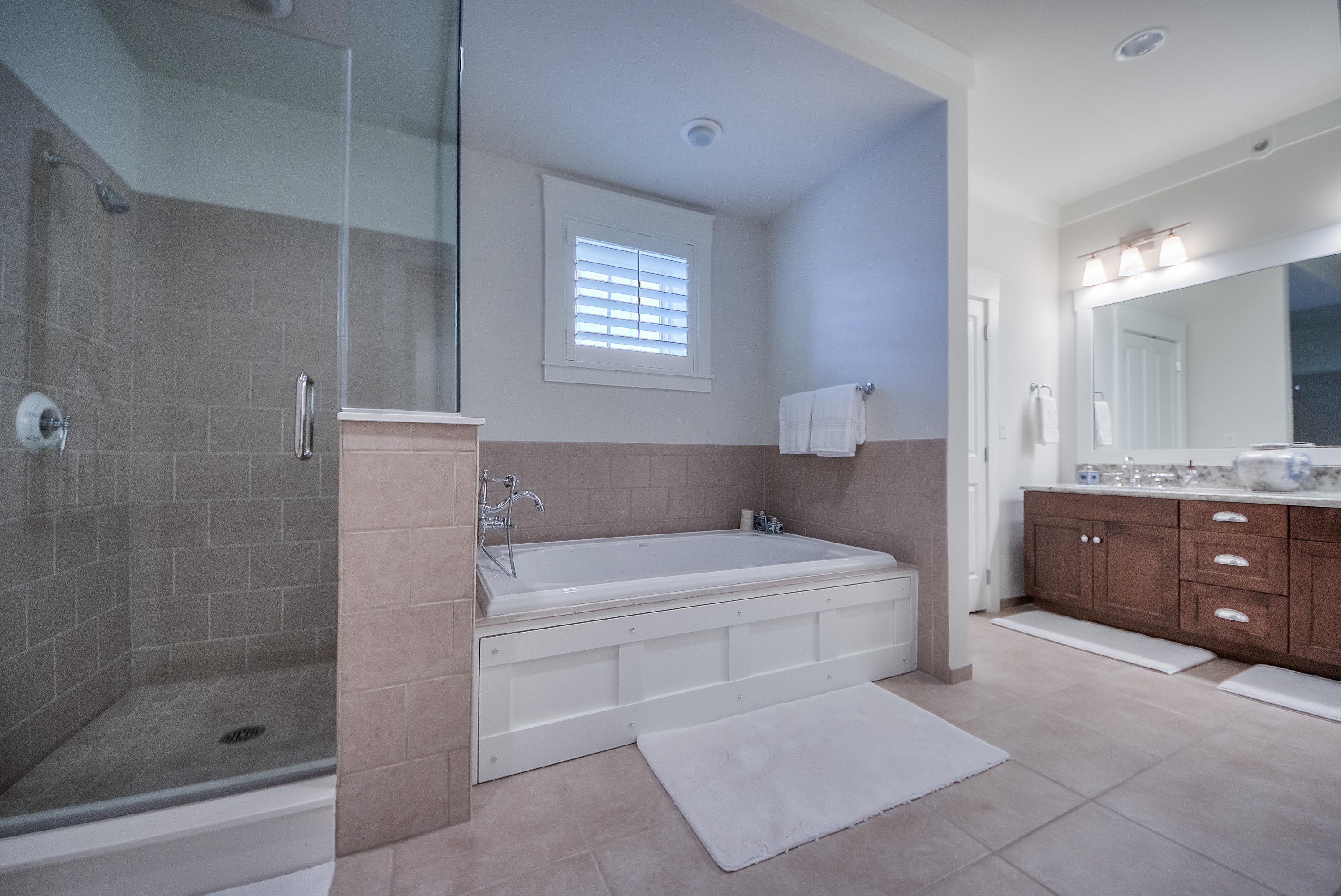 37 Compass Point Way, Unit 104 Watersound, FL 32461 - Photo 12 of 27 a spacious bathroom with a tub sink shower and mirror